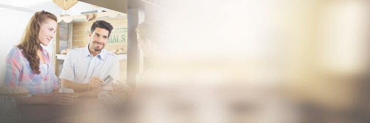 Fototapeta premium Couple paying bill at coffee shop using card