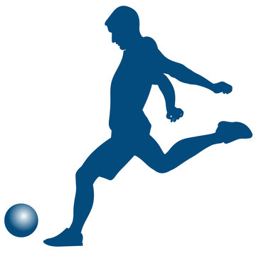 Silhouette of soccer player striking the ball