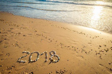 2018 New Year text on sand