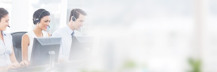 Call centre employees smiling while sitting