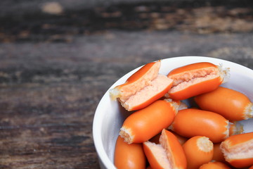 sausages boiled macro focus in white bowl on the wooden background.