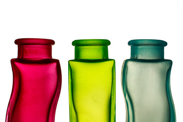 Primary colors. Top of red, green and blue decorative glass jars with blank space on top of the image
