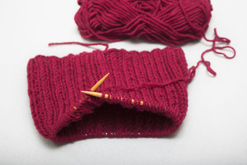 The process of knitting a scarf-snud on circular wooden knitting needles
