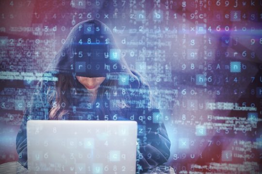Composite image of female hacker using laptop