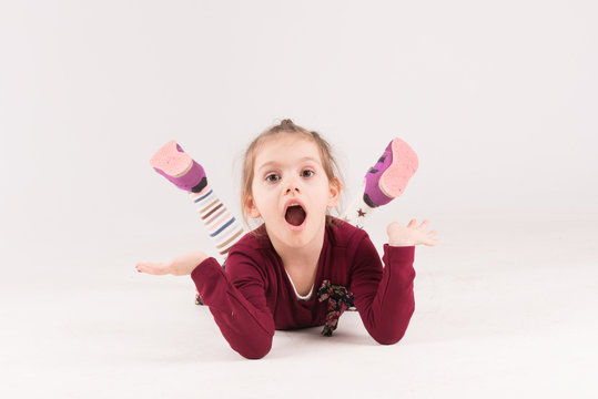 Little one with surprides and shocked expression on the floor
