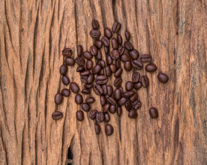 Roasted coffee beans on wood texture background