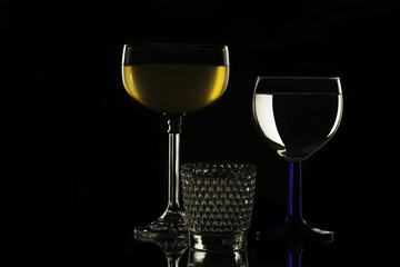 Wine, champagne glasses with alkohol on black background, glass dish for liquids concept