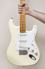 Fototapeta na wymiar Hand Holding White Vintage Electric Guitar
