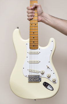 Hand Holding White Vintage Electric Guitar