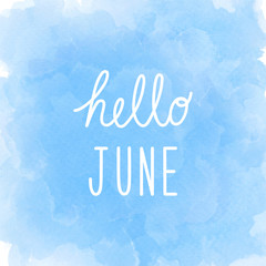 Hello June greeting on abstract blue watercolor background.