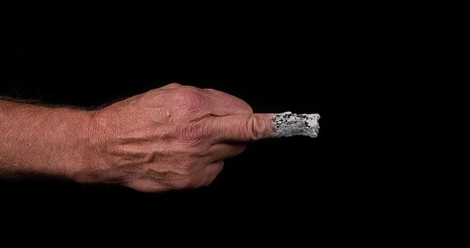 Hand of Man with a Finger that burns like a Cigarette, Slow motion 4K
