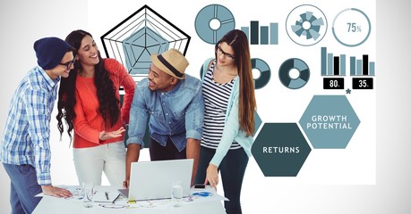 Casual business people with laptop against graphs