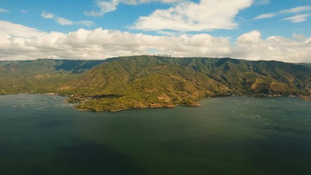 Fish Farm with floating cages in lake Taal. Aerial view: Fish farming with cages for whitebait on the surface of the water. Luzon, Philippines.