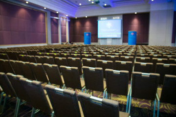 Abstract blurred photo of conference hall or seminar room with attendee background