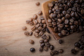 coffee beans isolated on wood background.