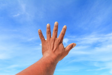 hand show counting number five on sky background