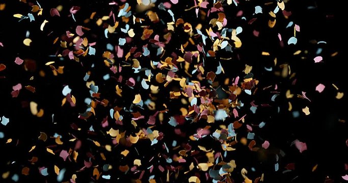 Confettis Falling against Black Background, Slow Motion 4K