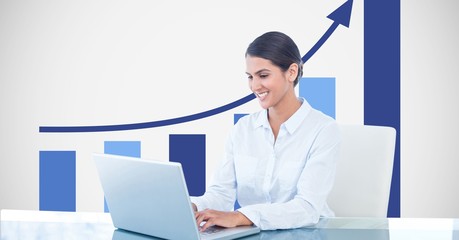 Smiling businesswoman using laptop 