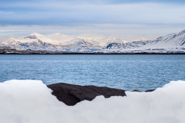Beautiful view of Iceland winter season with snow-capped mountain in the background and snow in the foreground
