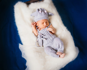 Baby sleeps on fluffy white pillow