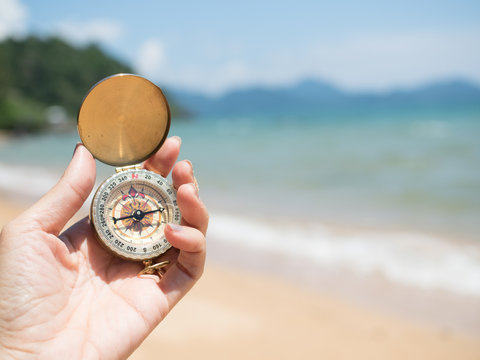 hand hold compass in beach for travel