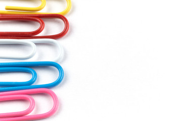 Colored clips on white paper, with nice paper texture