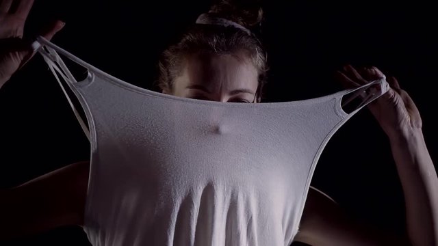 Portrait of a pretty girl model artistic moves and covering her face with clothes