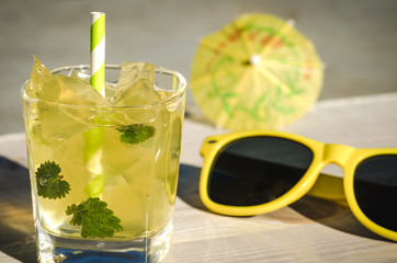 ice cocktail with mint and sunglasses outdoors/ice cocktail with mint and sunglasses