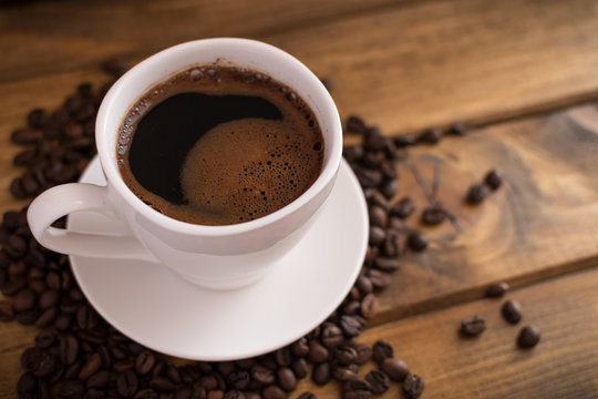 cup of black coffee on wooden background