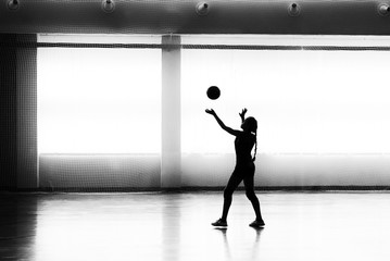 Fototapeta na wymiar Girl playing volleyball in the sports club