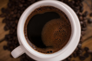 cup of black coffee on wooden background