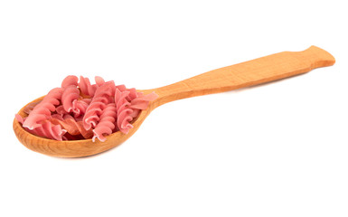 Red fusilli pasta in spoon on white background