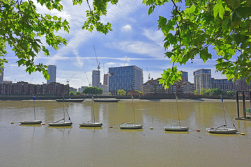 Thames river from the North Bank showing sailboats tied up in the river, Nine Elms on the South Bank and the site of the new U.S. Embassy in London.