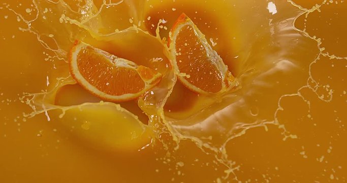 Orange, citrus sinensis, Fruit falling into Orange Juice, Slow Motion 4K