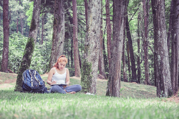 Women write notes Nature trails, mountains, forests. Writer