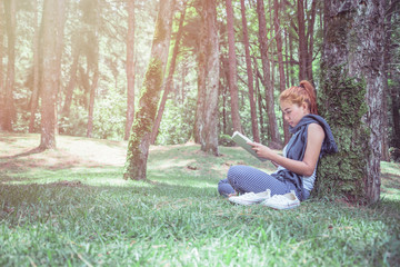 Woman relaxing reading in park. holiday