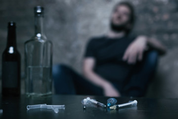 Several medical syringes lying in the dark lighted room