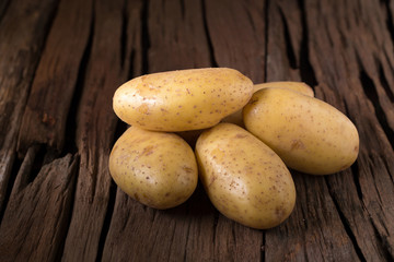 Potatoes on wooden table. Selective focus
