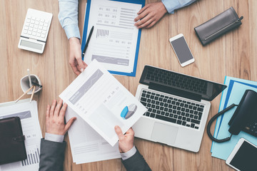 Business people examining reports