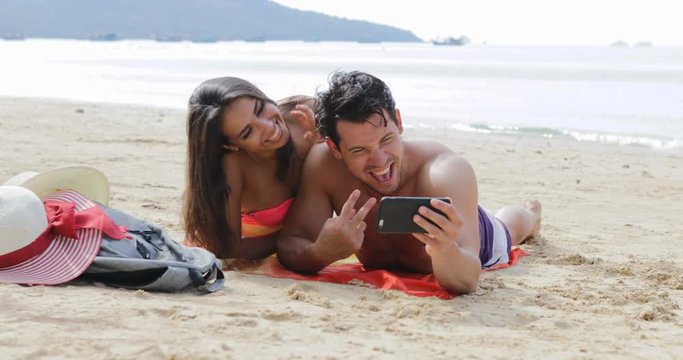Couple Lying On Beach Taking Selfie Photo On Cell Smart Phone Talking, Young Man And Woman On Seashore Tourists On Summer Vacation Slow Motion 60