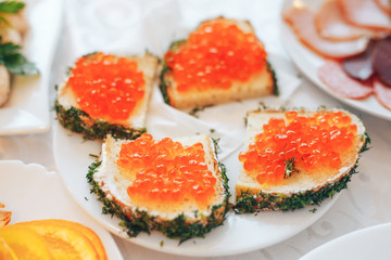 Sandwich with red caviar. Butter, black bread and red caviar