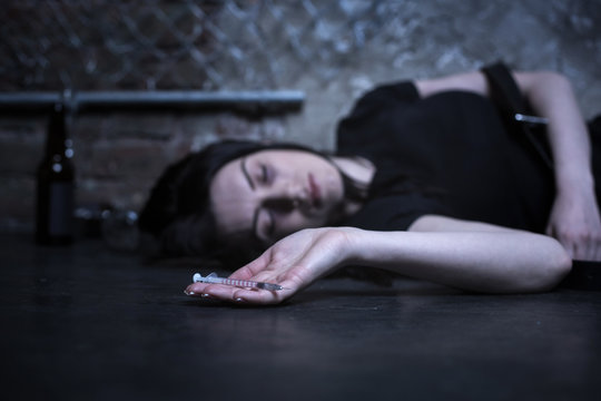 Prostrate junky lying on the ground
