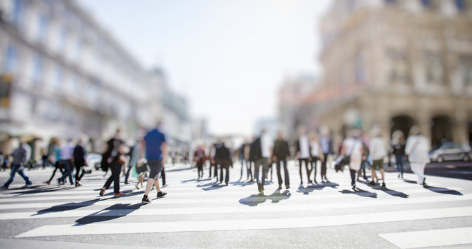Fototapeta Crowd of anonymous people walking on busy city street