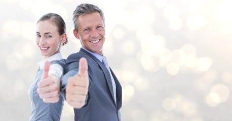 Portrait of business people showing thumbs up