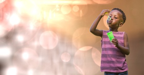 Kid blowing bubbles over blur background