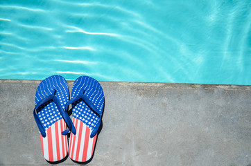 Naklejka premium Summer background with flip flops near the pool