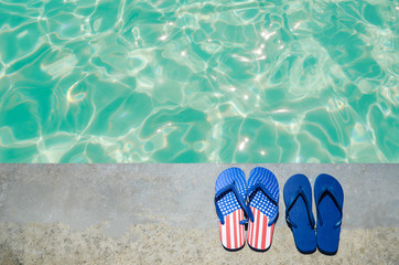 Naklejka premium Summer background with flip flops near the pool