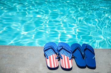 Naklejka premium Summer background with flip flops near the pool