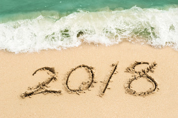 writing 2018 on the sand, happy new year