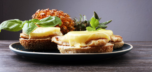 toast hawaii, , cheese and pineapple on wooden background with chicken breast
